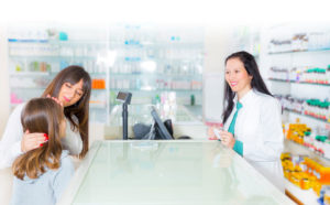 Mother and Daughter interacting with Pharmacist