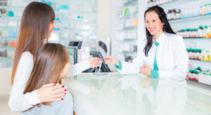 Mother and Daughter interacting with Pharmacist